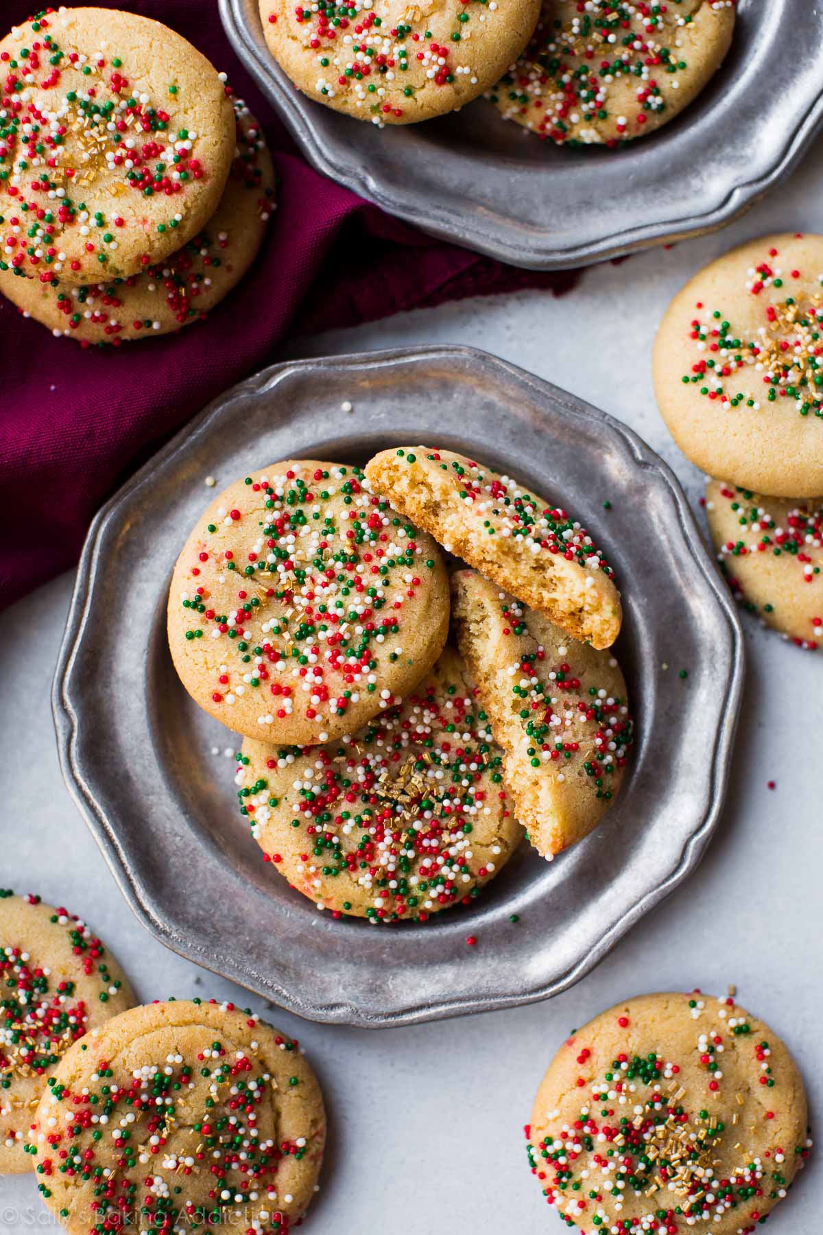 brown butter sugar cookies with Christmas sprinkles on silver plates
