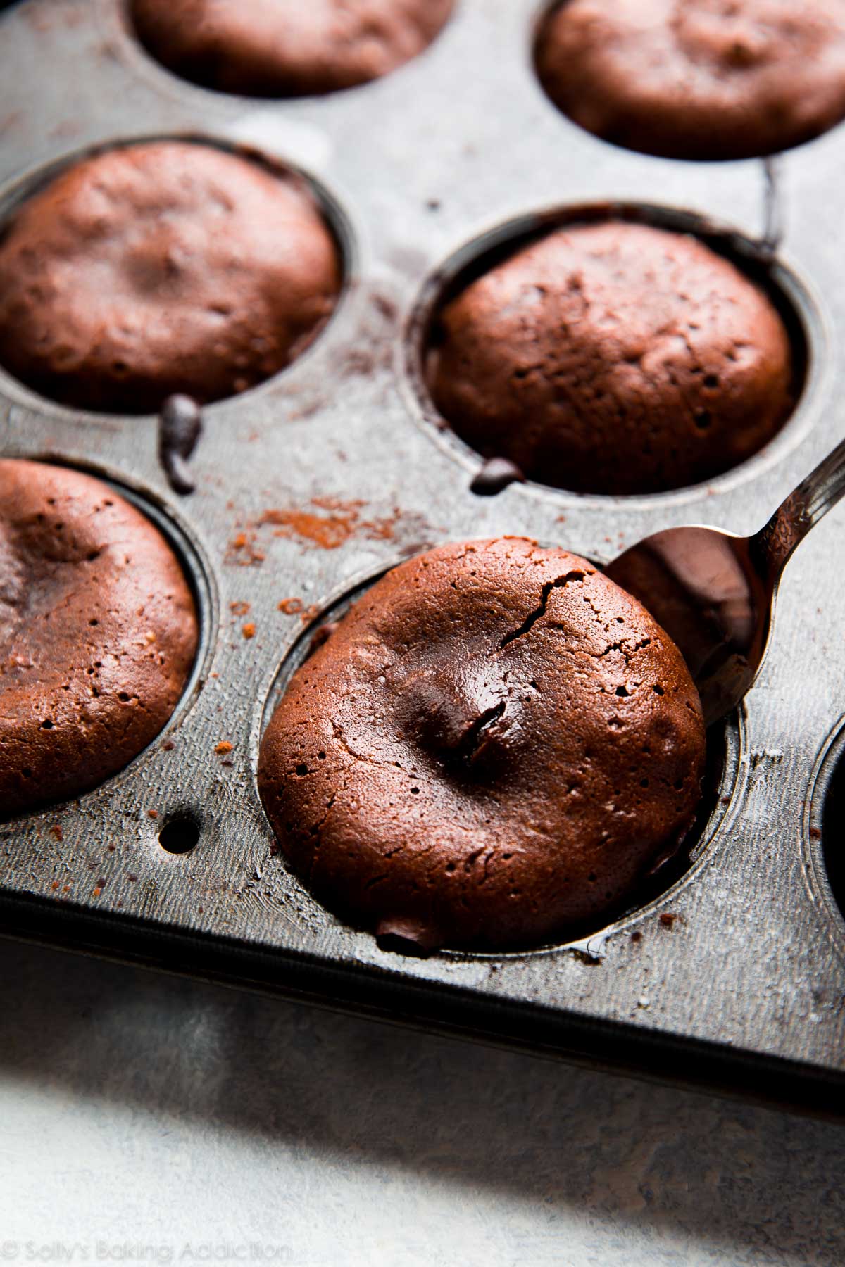 chocolate lava cakes in a muffin pan after baking