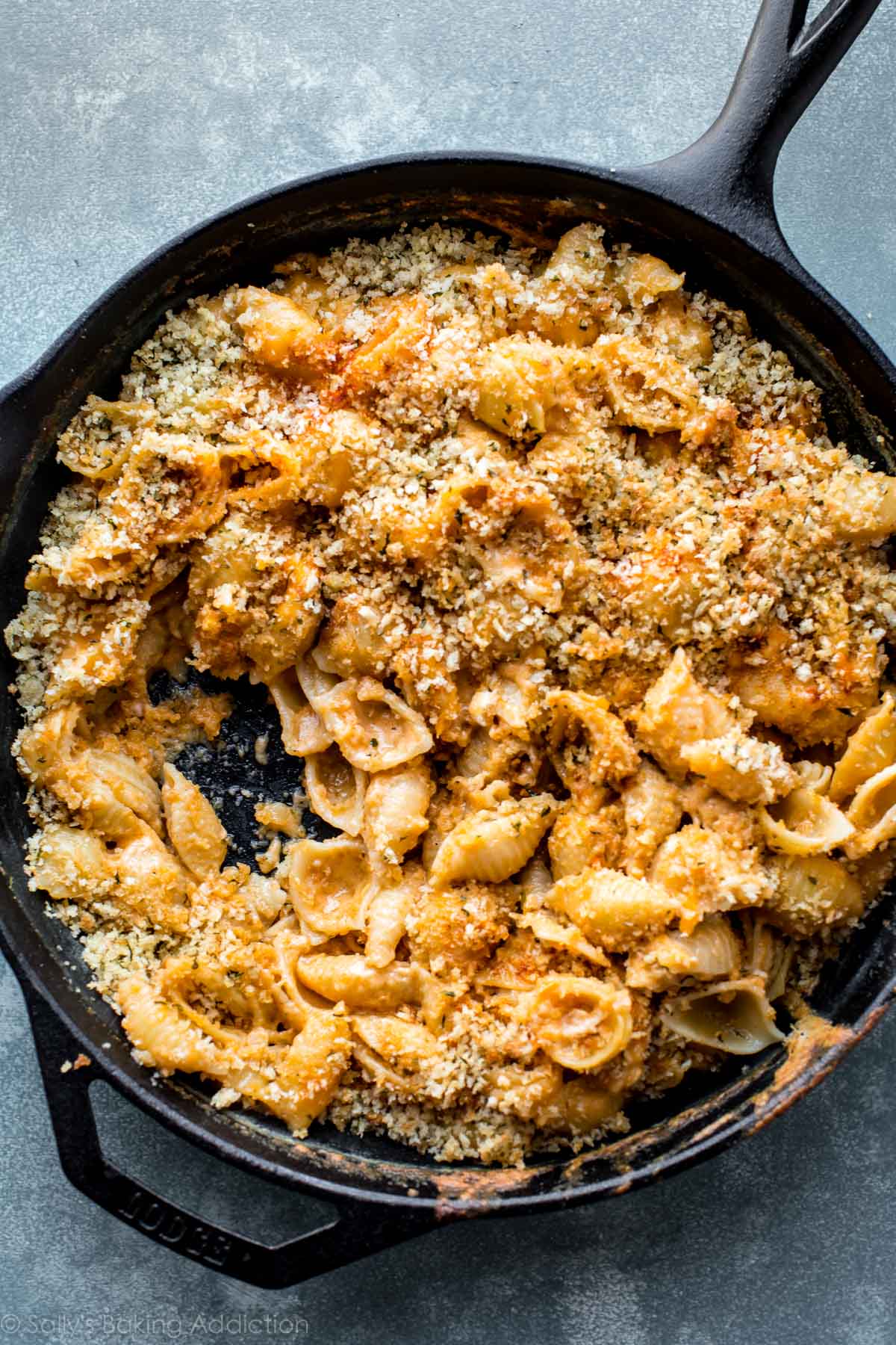 overhead image of baked macaroni and cheese in a cast iron skillet