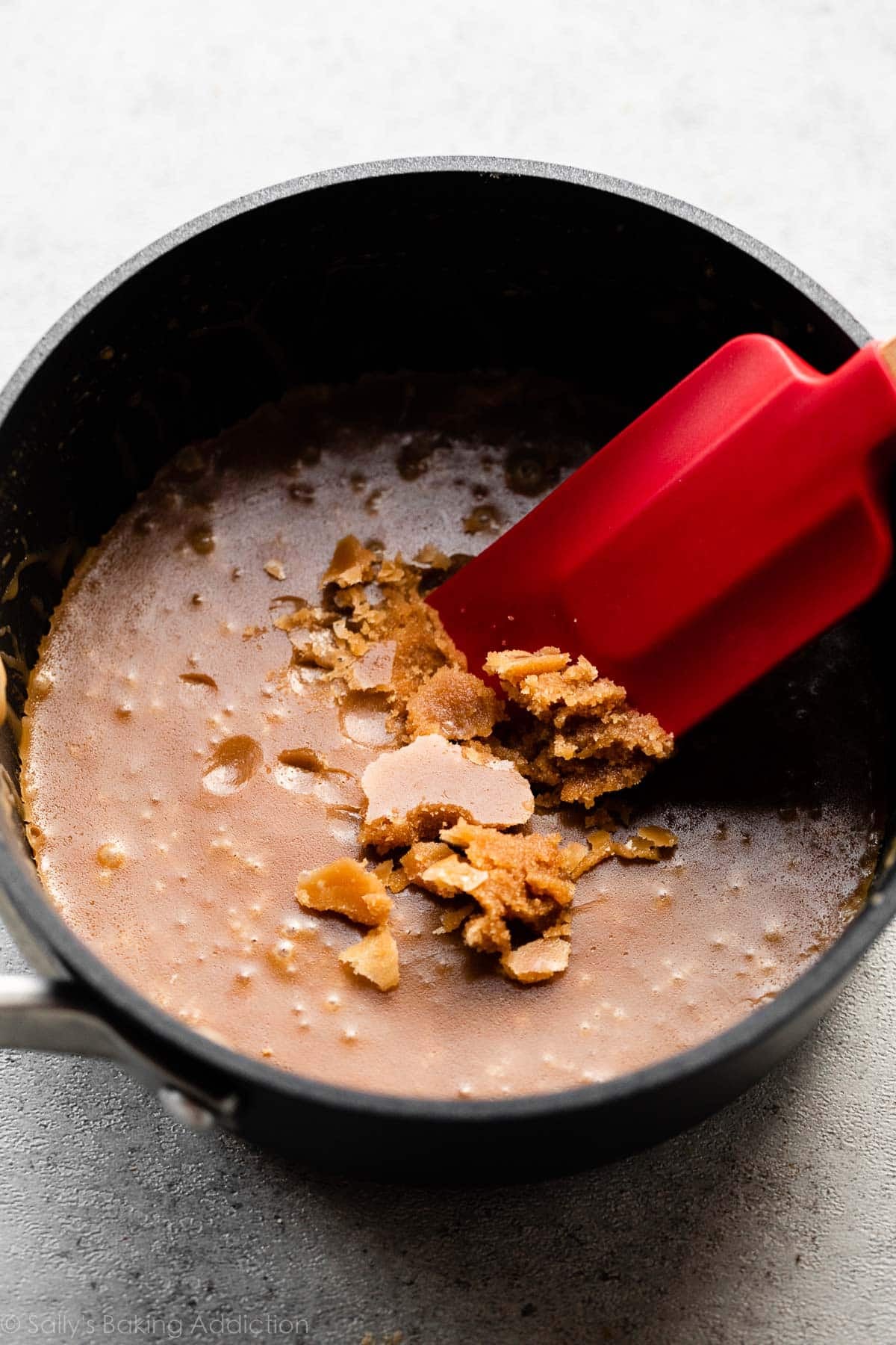 over-cooked and grainy brown sugar caramel mixture in pot.