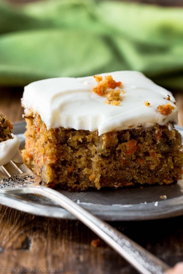 slice of pineapple carrot cake on a silver plate with a fork