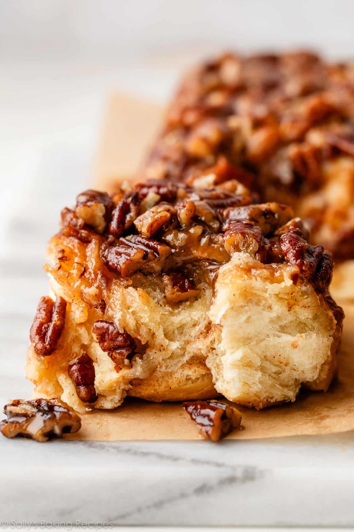 close-up of a biten pecan sticky bun.