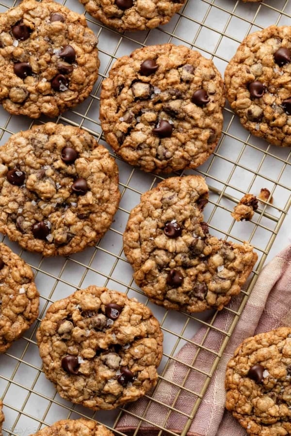 oatmeal chocolate chip cookies on gold cooling rack.