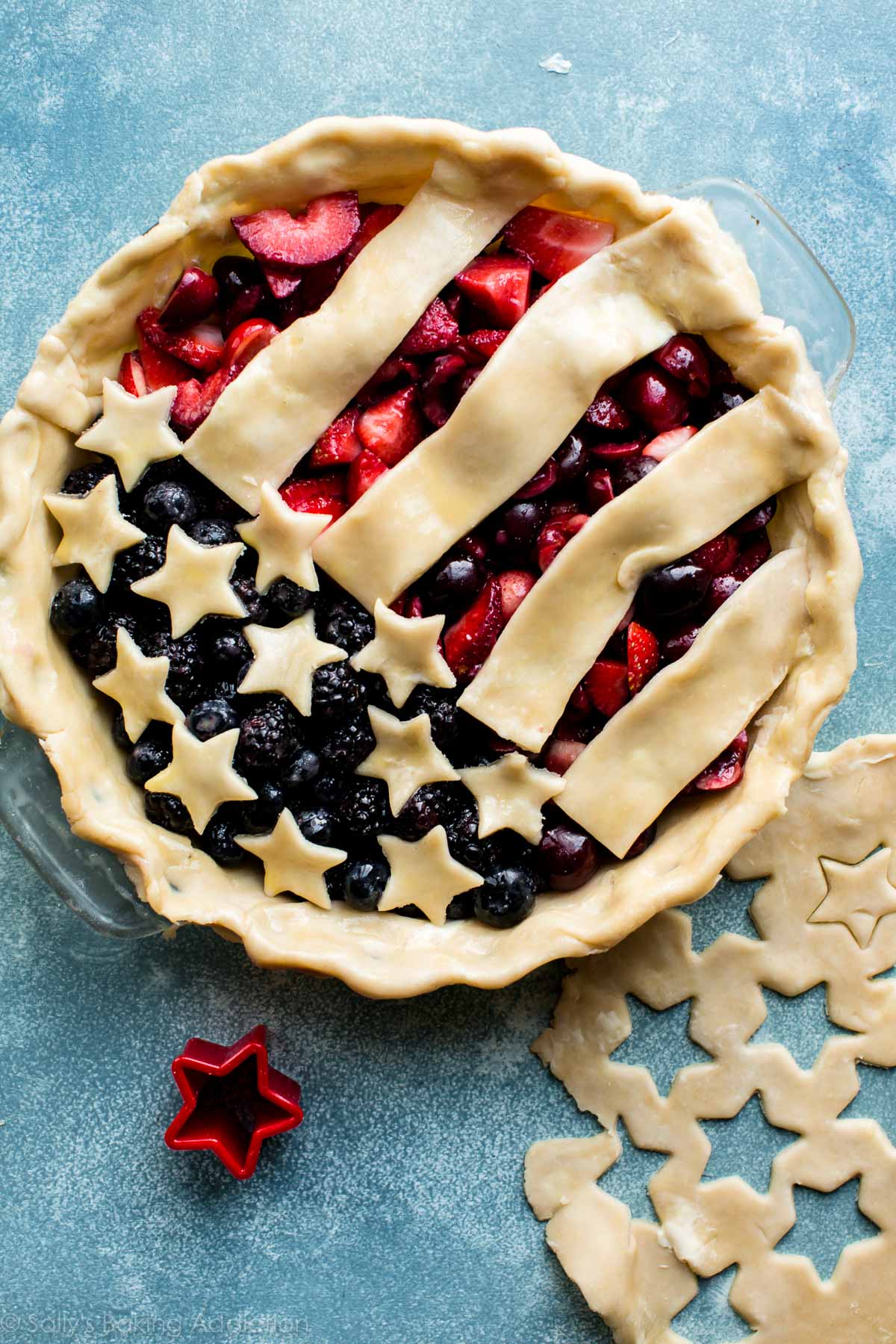 mixed berry pie topped with stars and stripes pie dough for a top crust