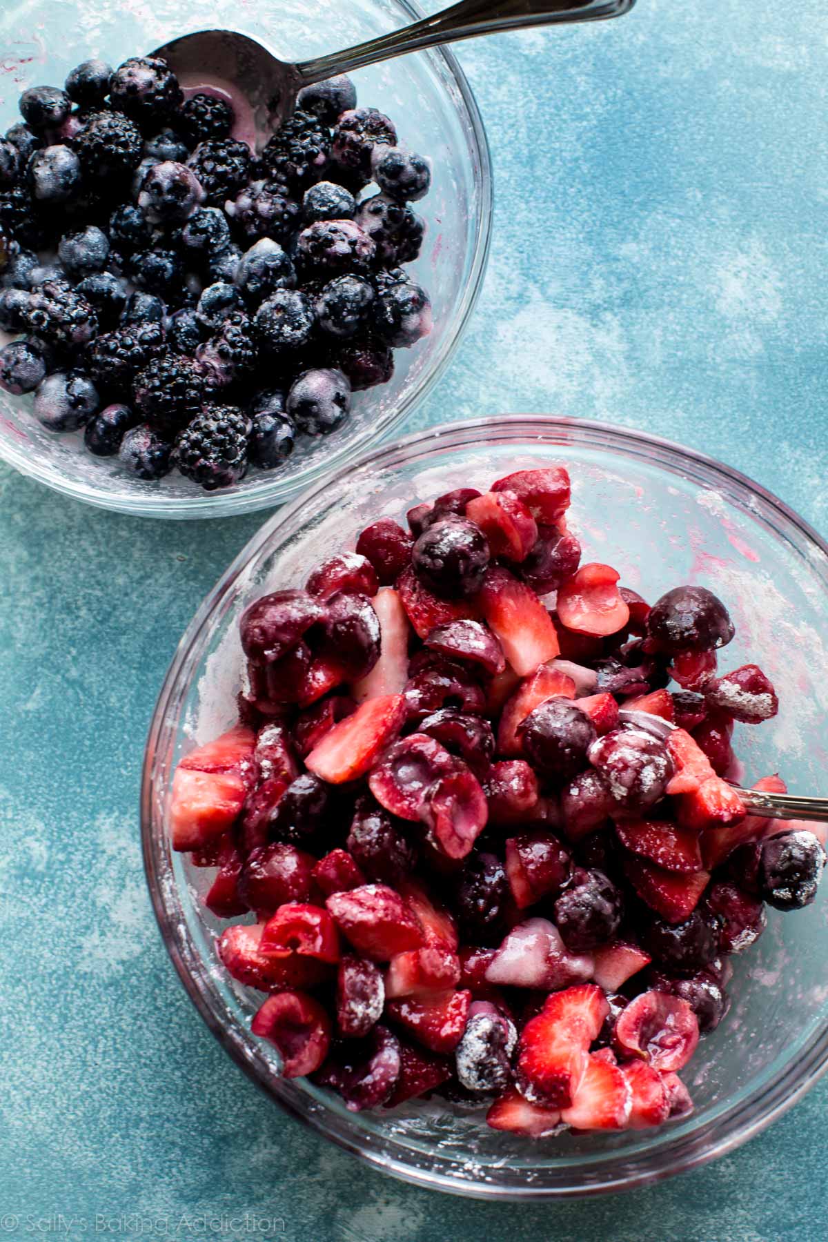 blackberry and blueberry pie filling in a glass bowl and strawberry and cherry pie filling in a glass bowl