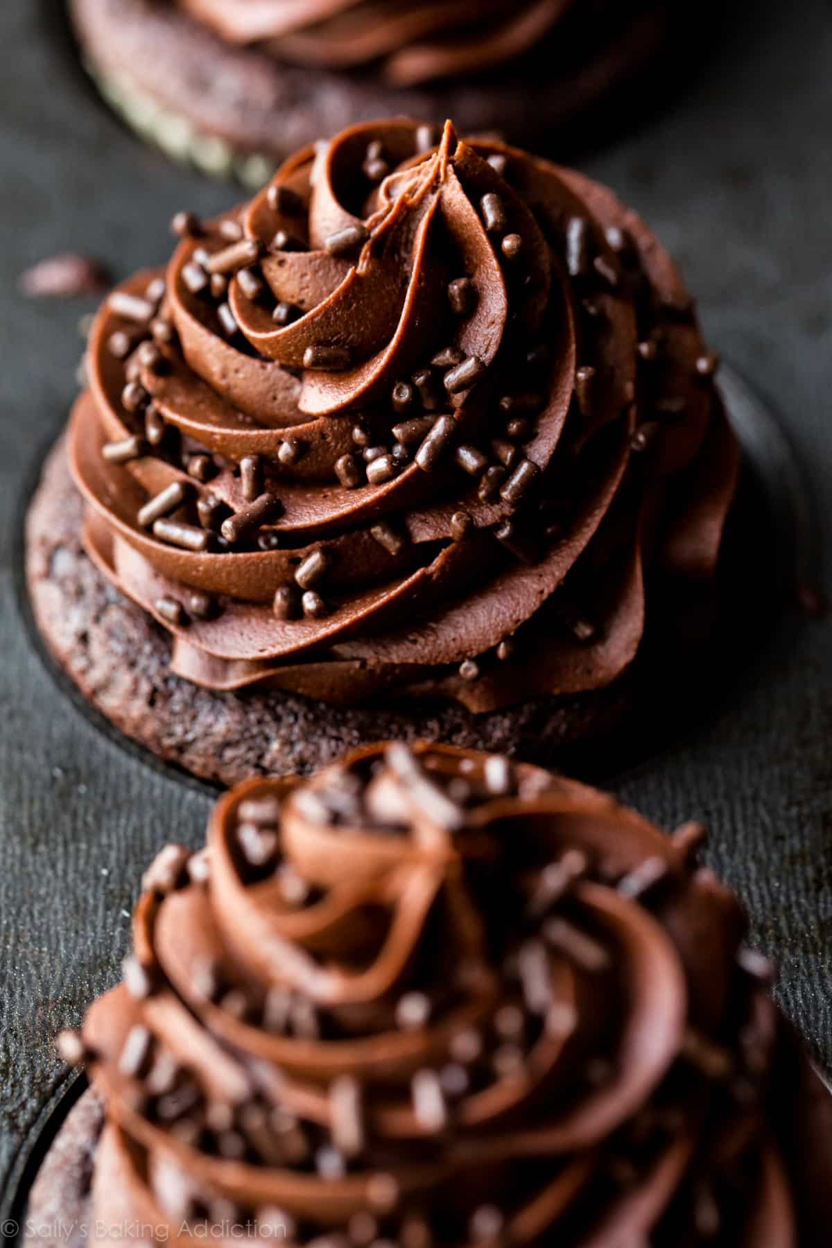 chocolate cupcakes with chocolate buttercream in a cupcake pan