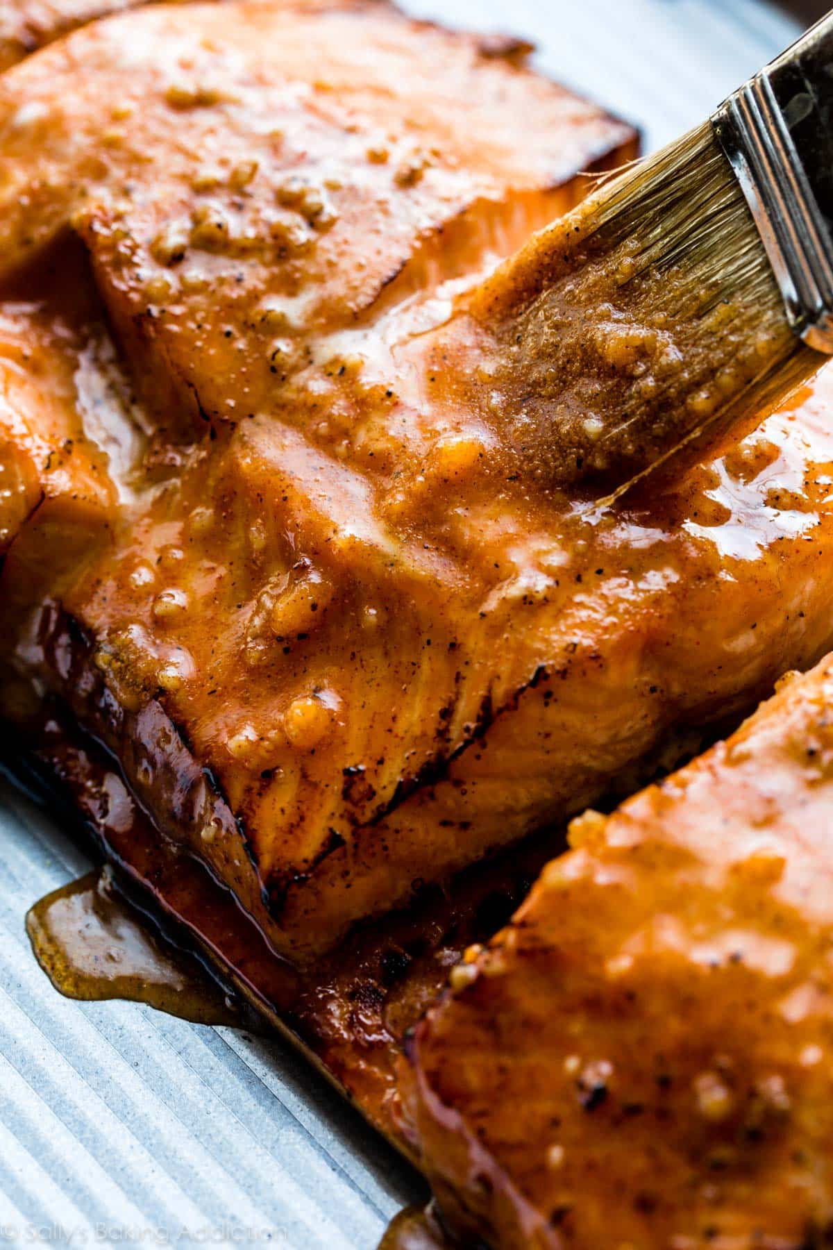 brushing marinade onto salmon