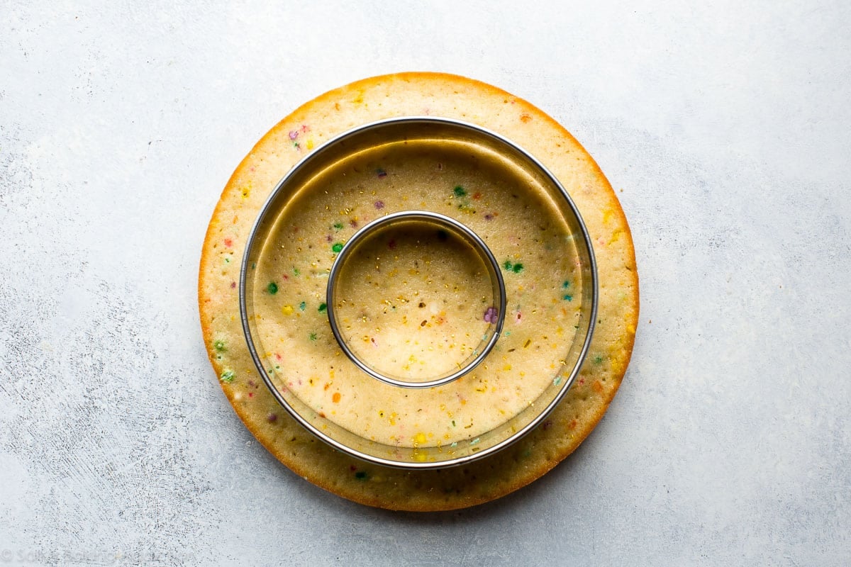 funfetti cake layer with 2 circle cutters creating 3 rings of cake