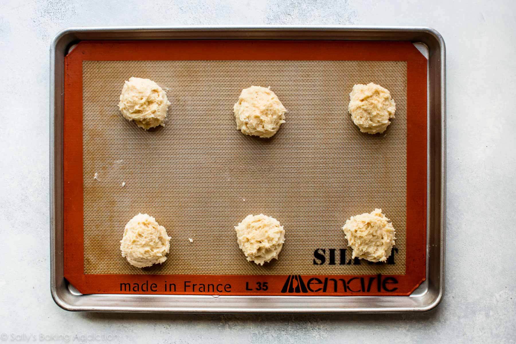 cookie dough on a baking sheet before baking
