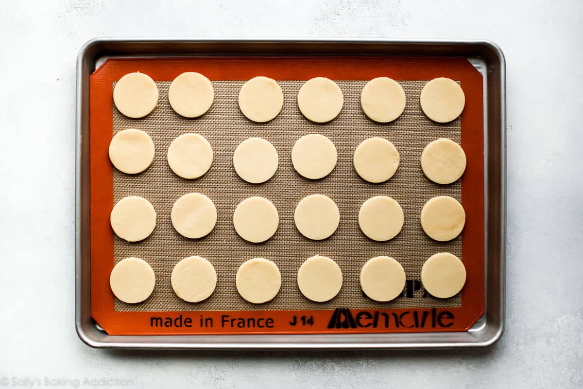 circles of cookie dough on a baking sheet before baking