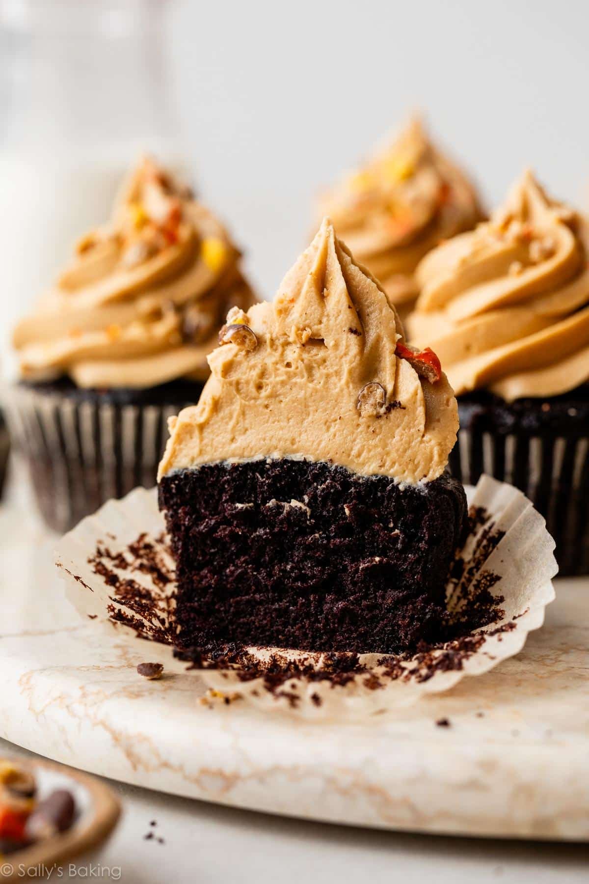 chocolate peanut butter frosting cupcake cut in half.
