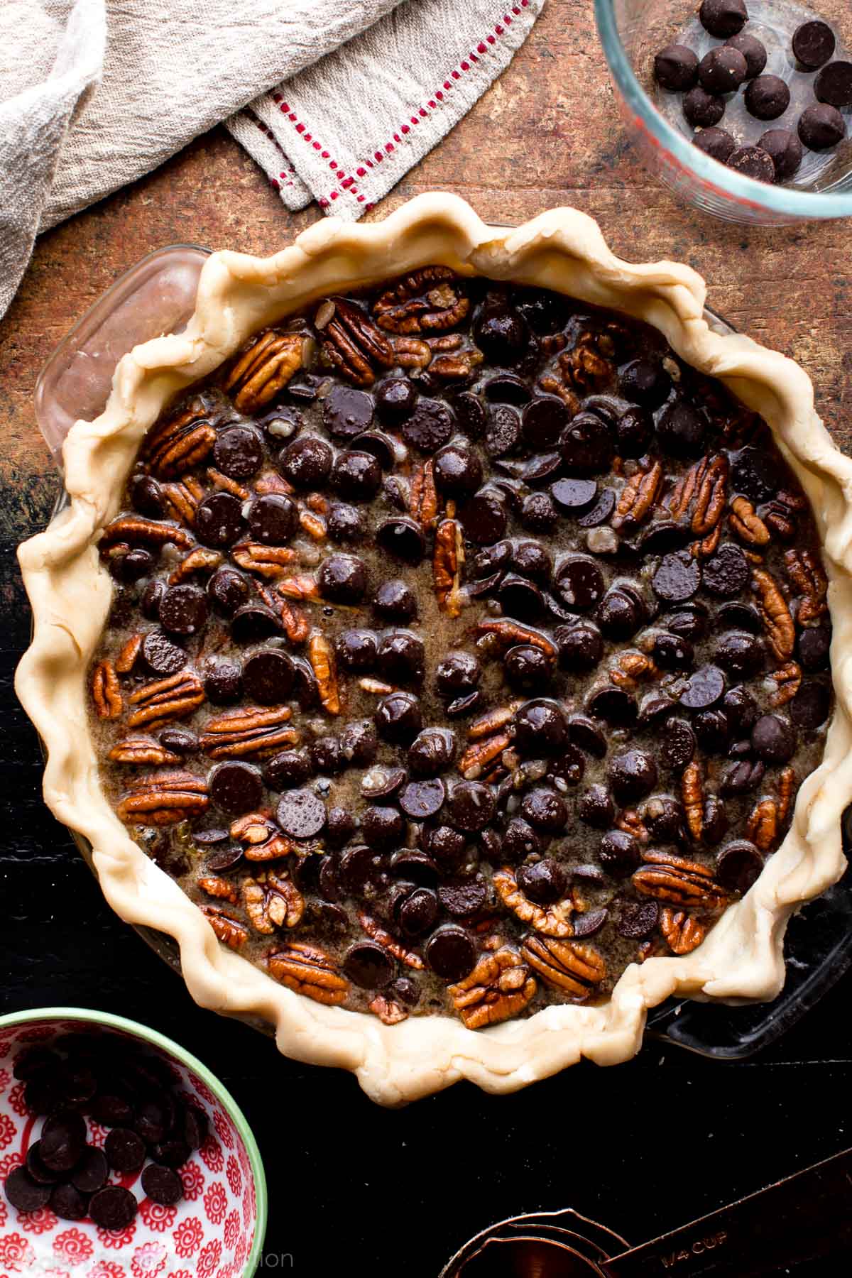 overhead image of dark chocolate pecan pie before baking