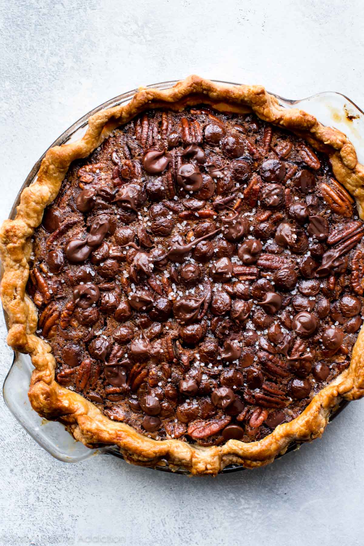 dark chocolate pecan pie in a glass pie dish