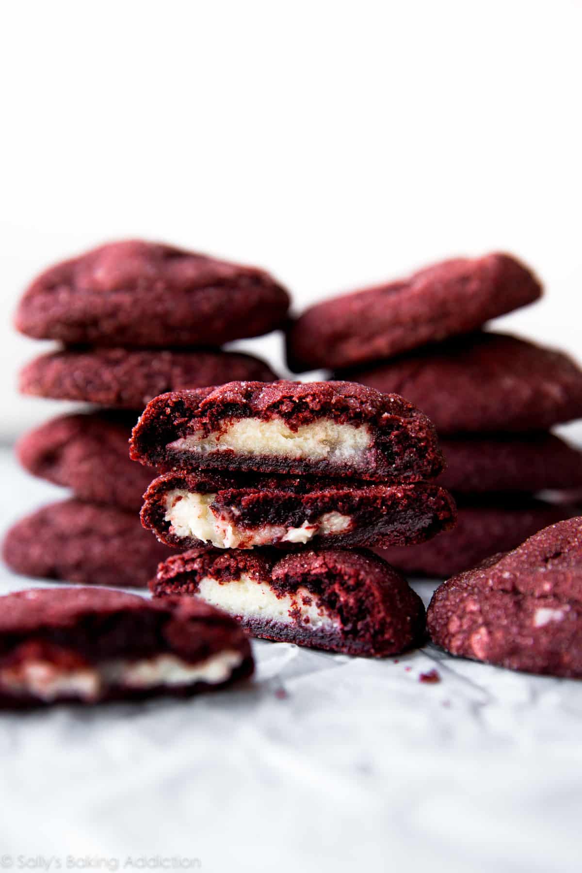 stacks of cream cheese stuffed red velvet cookies