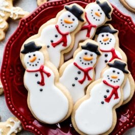 snowman sugar cookies on a red plate
