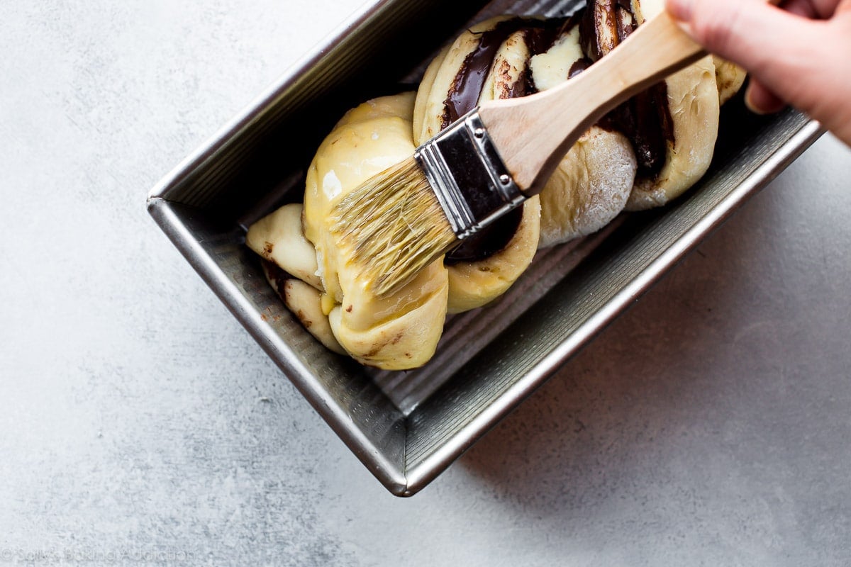 brushing babka with egg and milk mixture before baking
