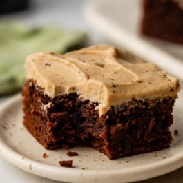 Guinness brownie with Guinness frosting on plate.