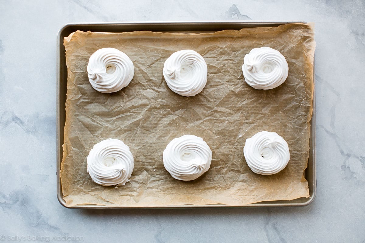 mini pavlovas on a baking sheet