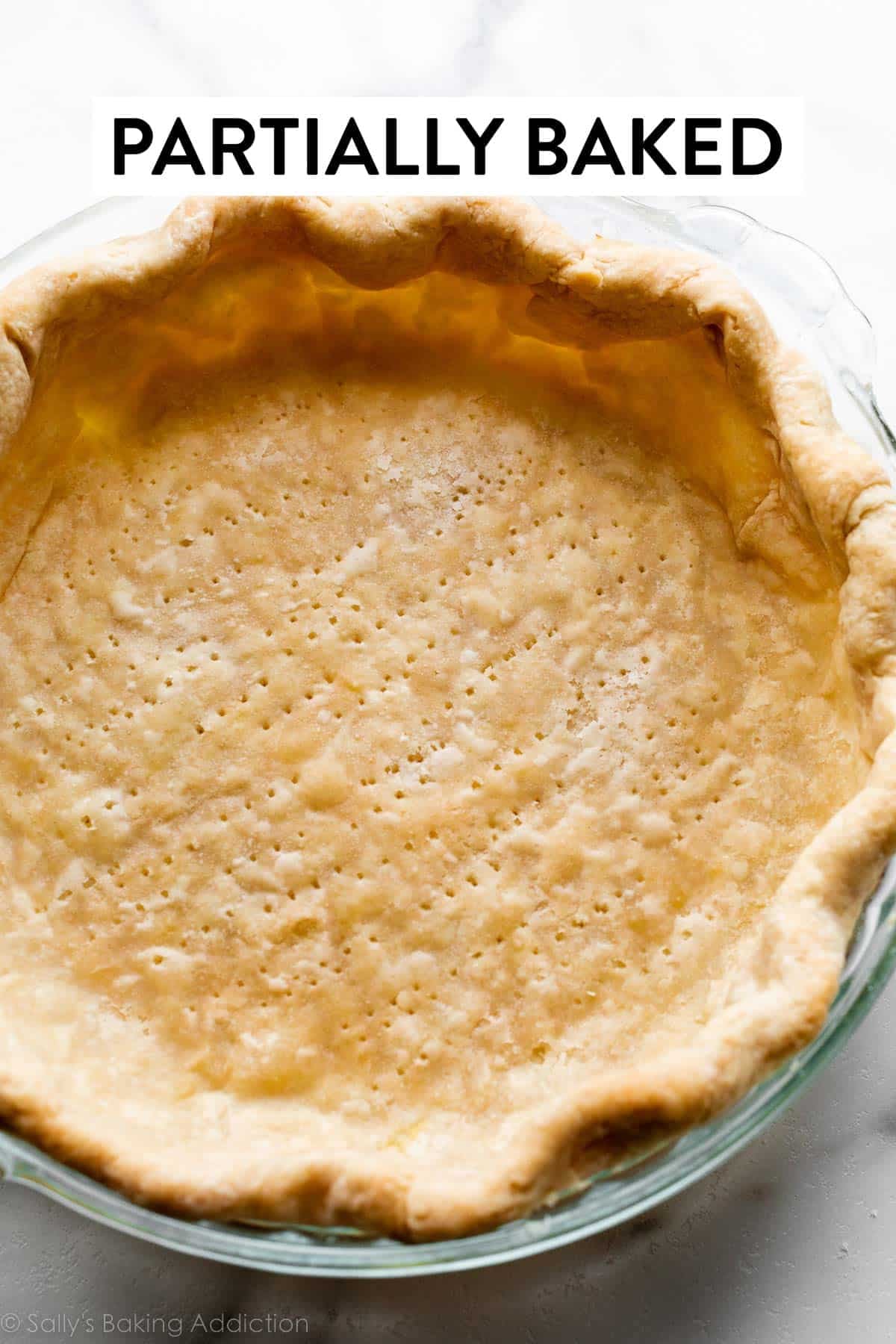 par-baked pie crust shell in glass pie dish.