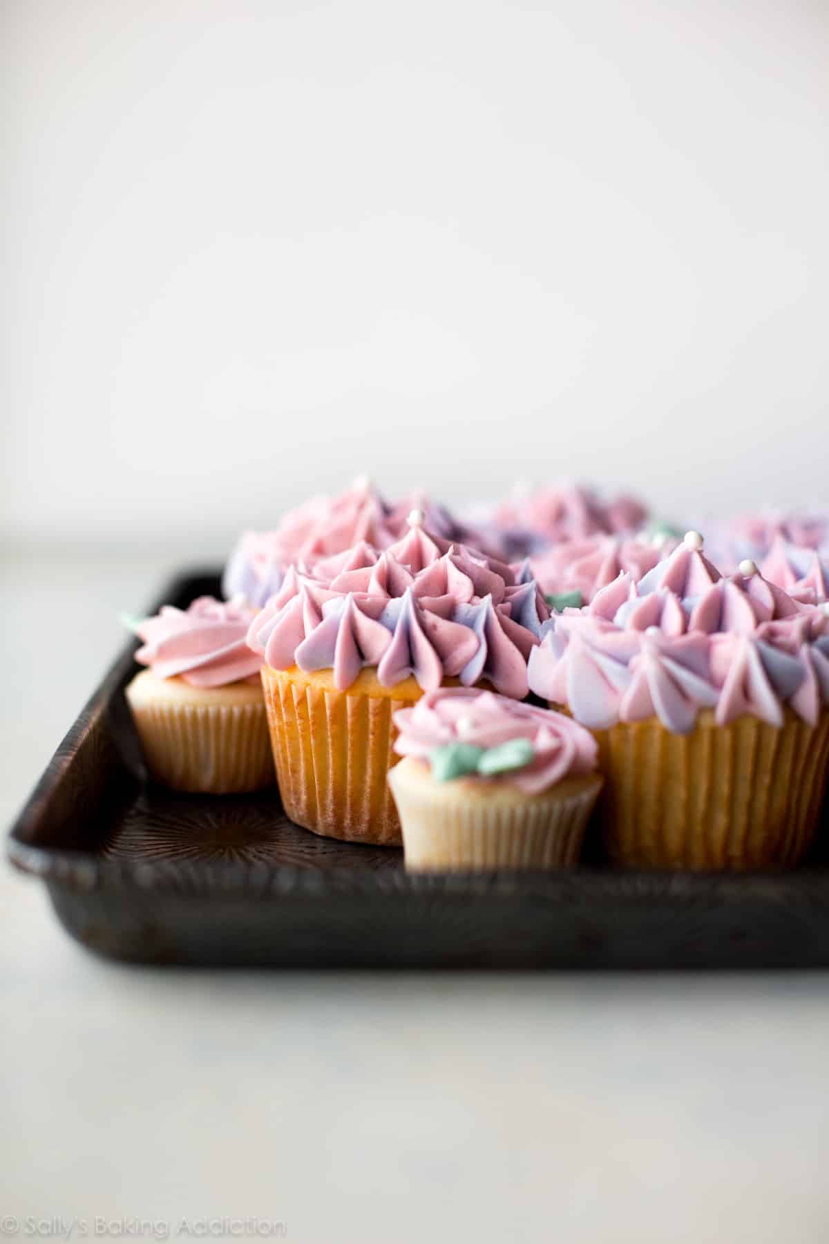 cupcakes decorated with buttercream like hydrangea and roses