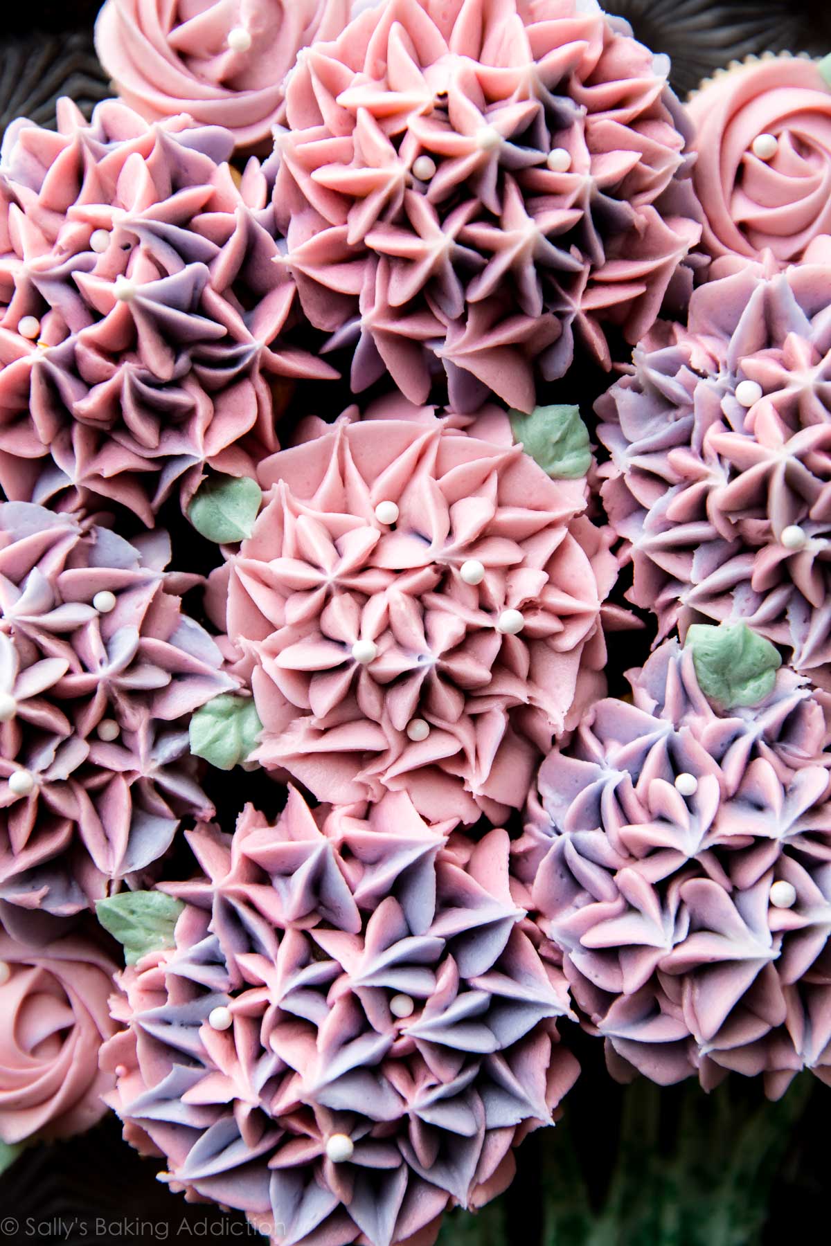 cupcakes decorated with buttercream like hydrangea and roses