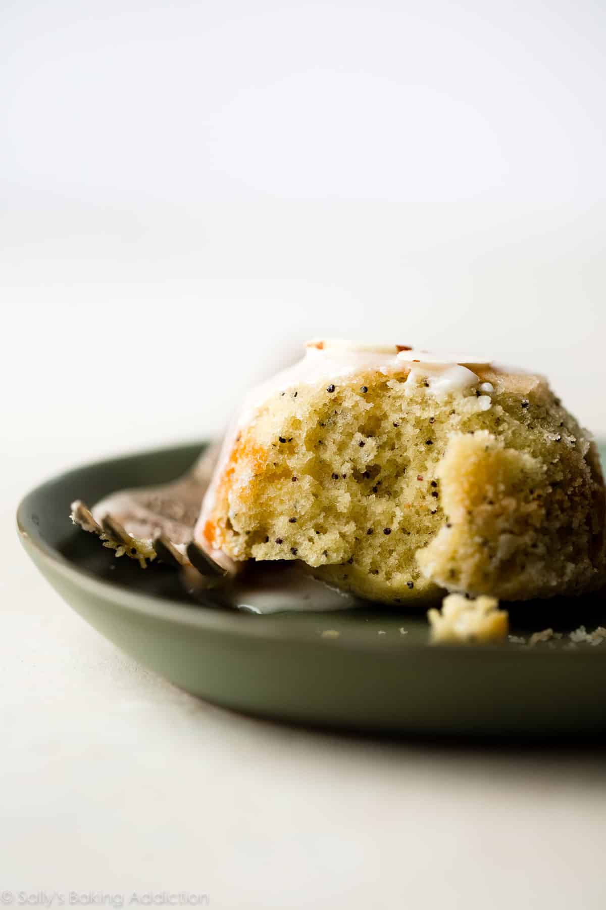almond poppy seed tea cake on a green plate