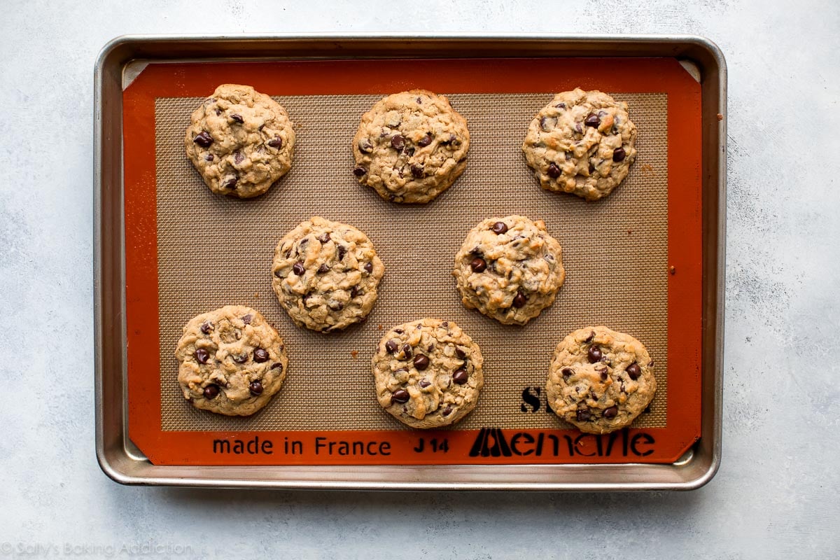 peanut butter oatmeal chocolate chip cookies on a baking sheet after baking