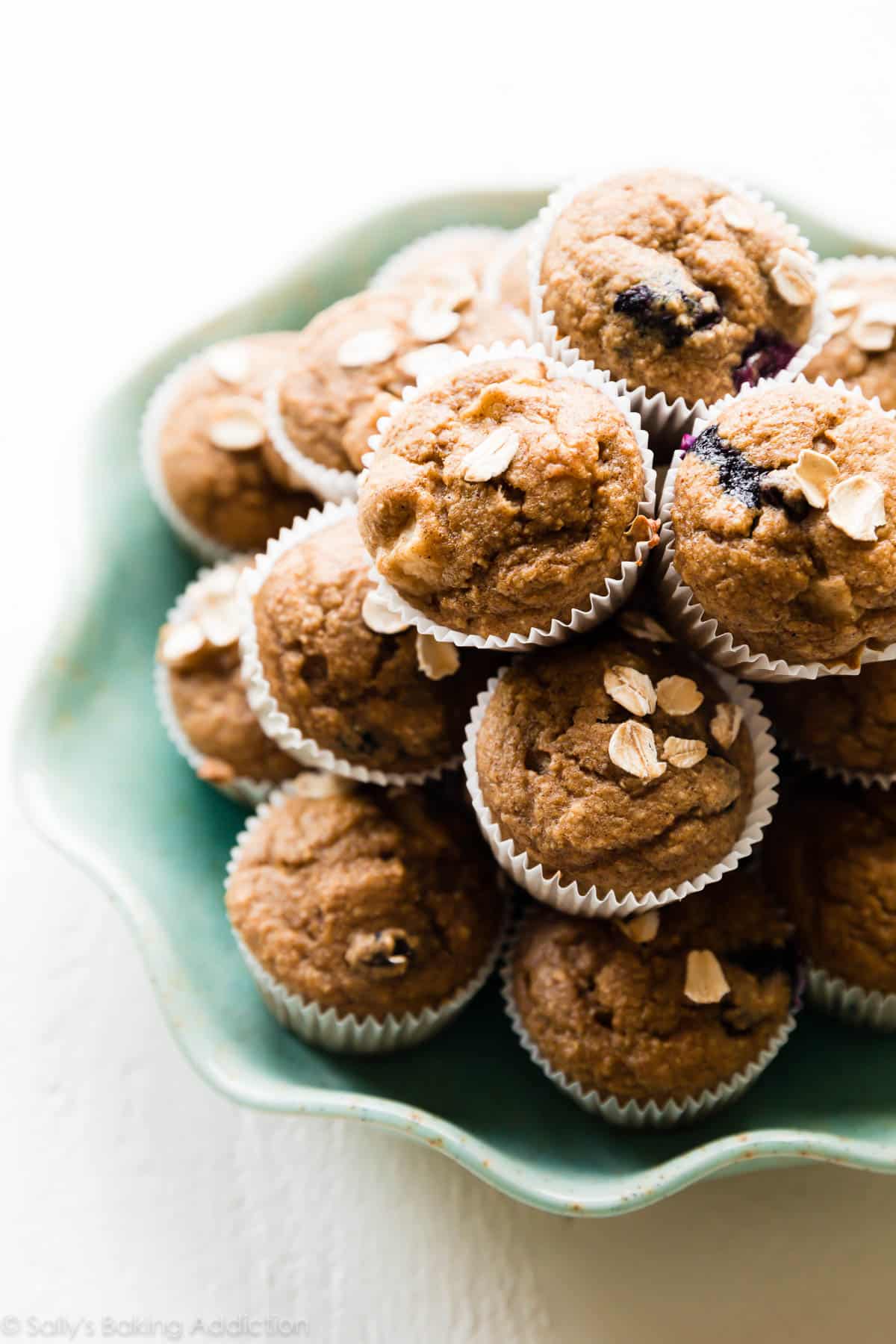 mini muffins stacked on a teal plate