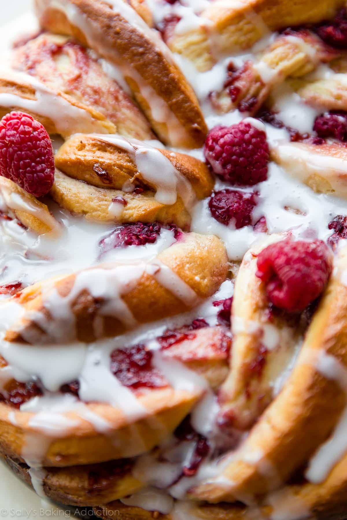Flaky buttery raspberry danish twist bread with vanilla icing