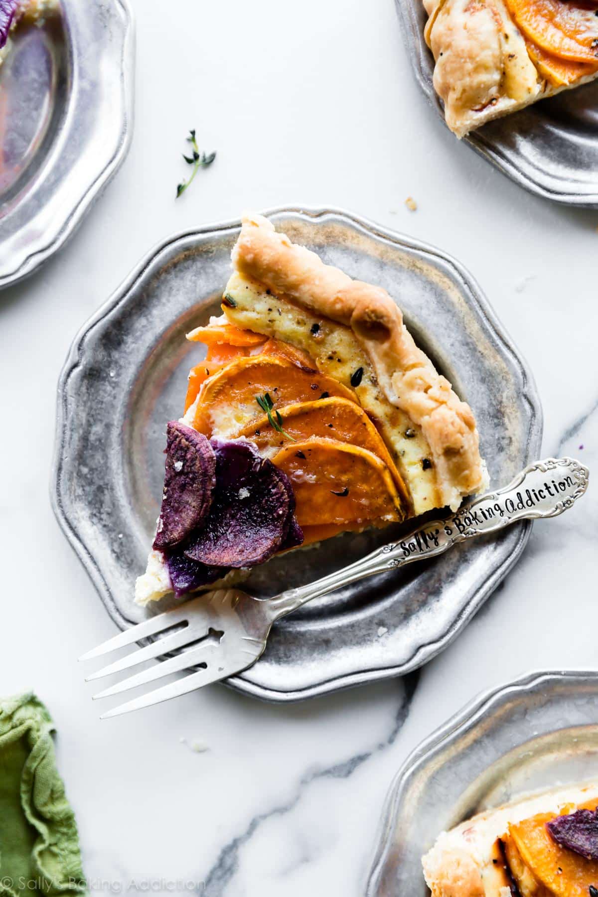 slices of vegetable and cheese tart on silver plates