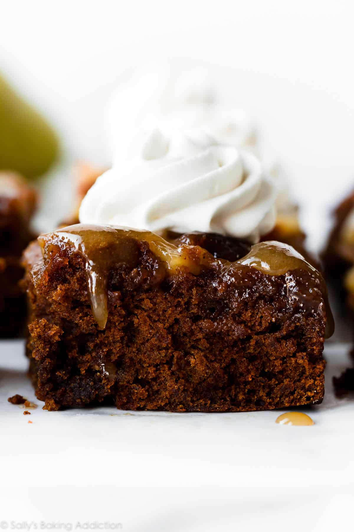 slice of upside-down pear gingerbread with whipped cream