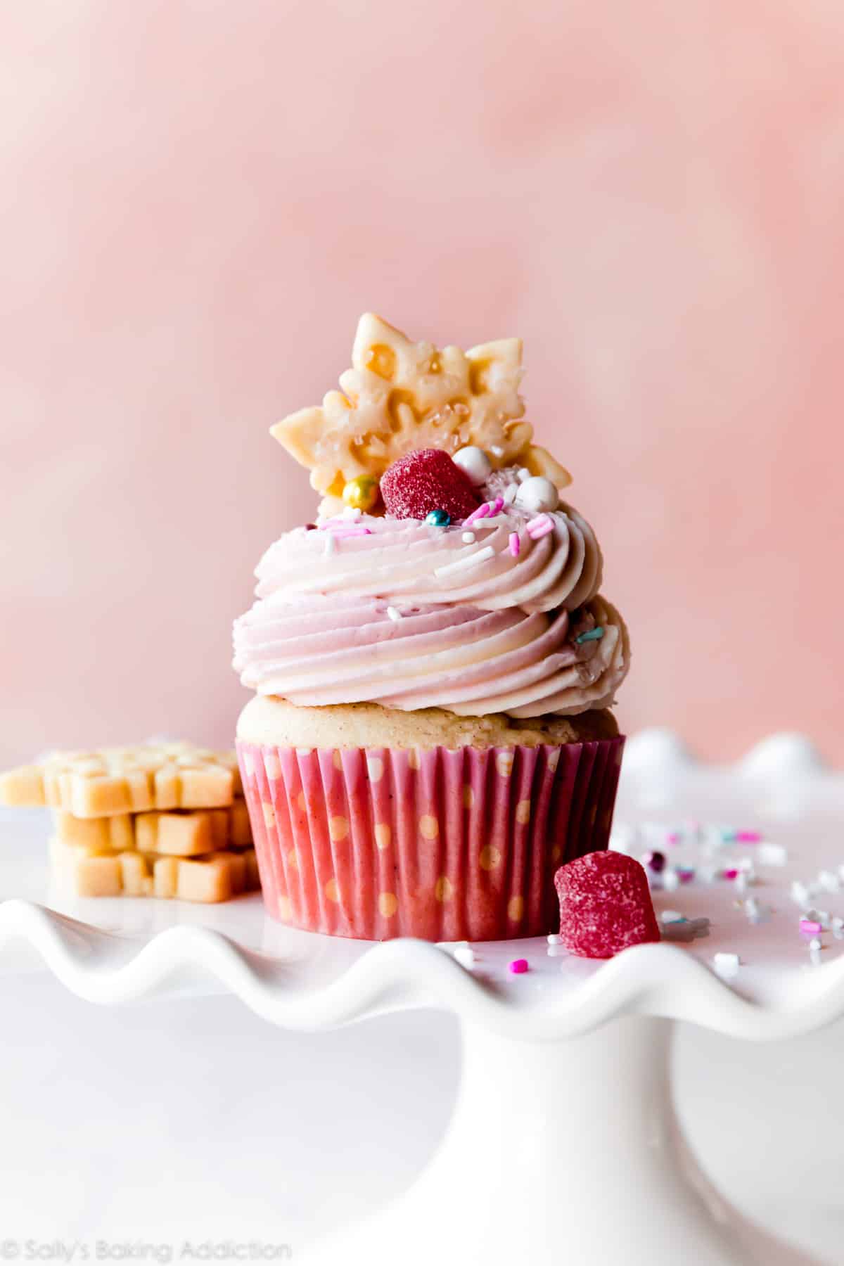 Nutcracker sugar plum fairy cupcake with snowflake sugar cookies on a white cake stand