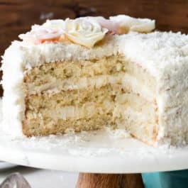 Coconut cake on a wood and marble cake stand