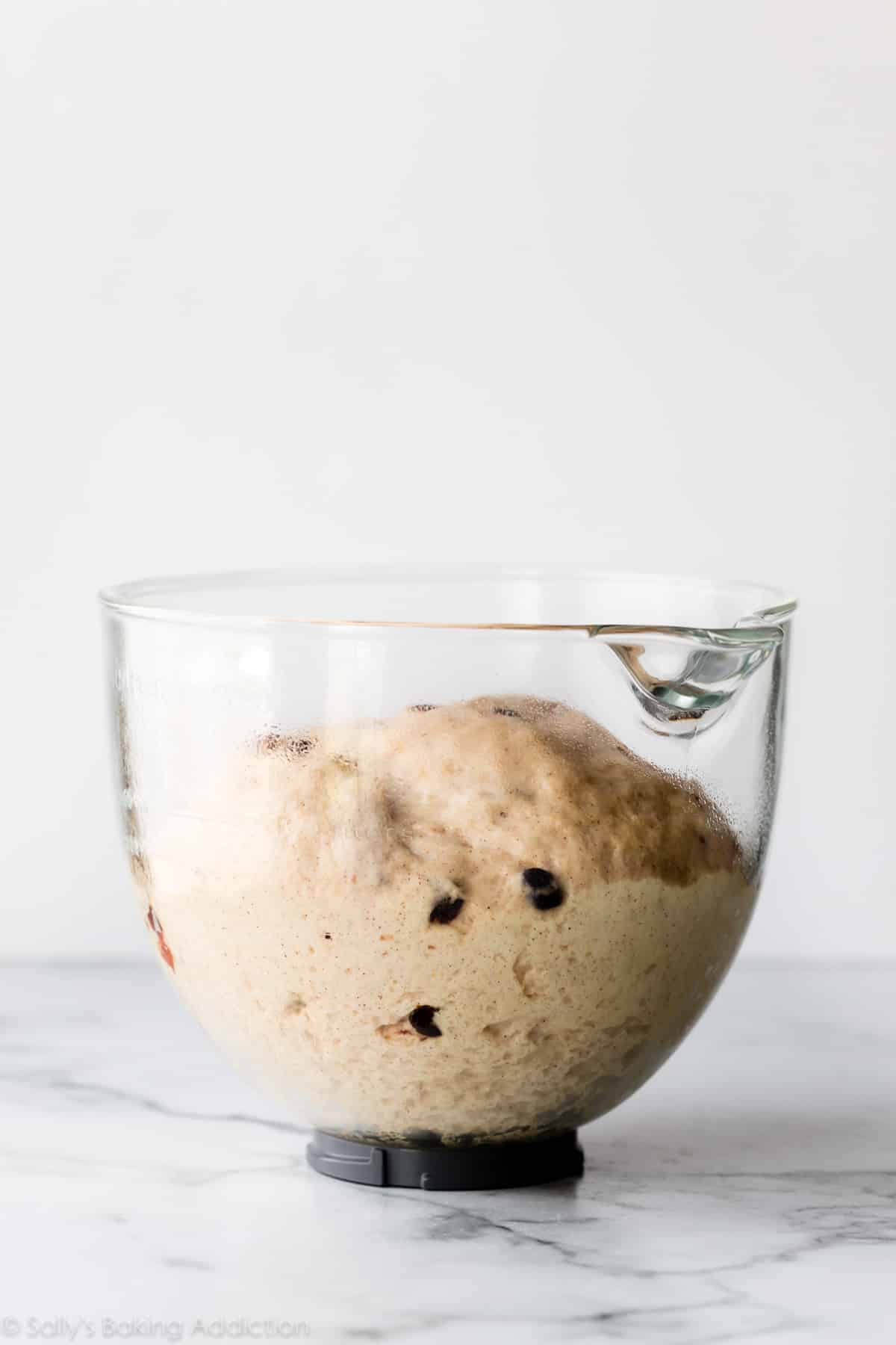 Hot cross bun dough in a glass bowl
