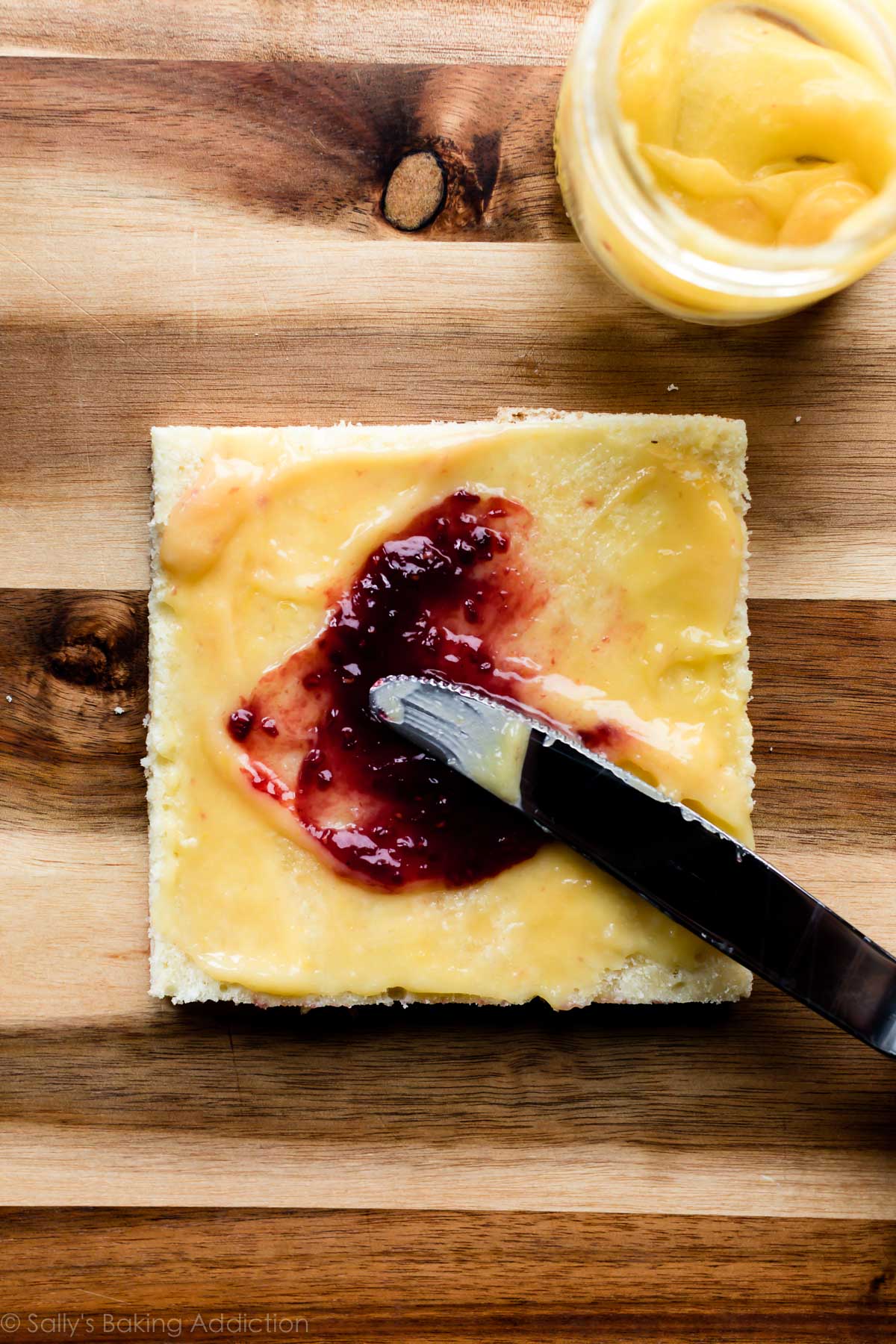 Spreading jam on petit fours layers