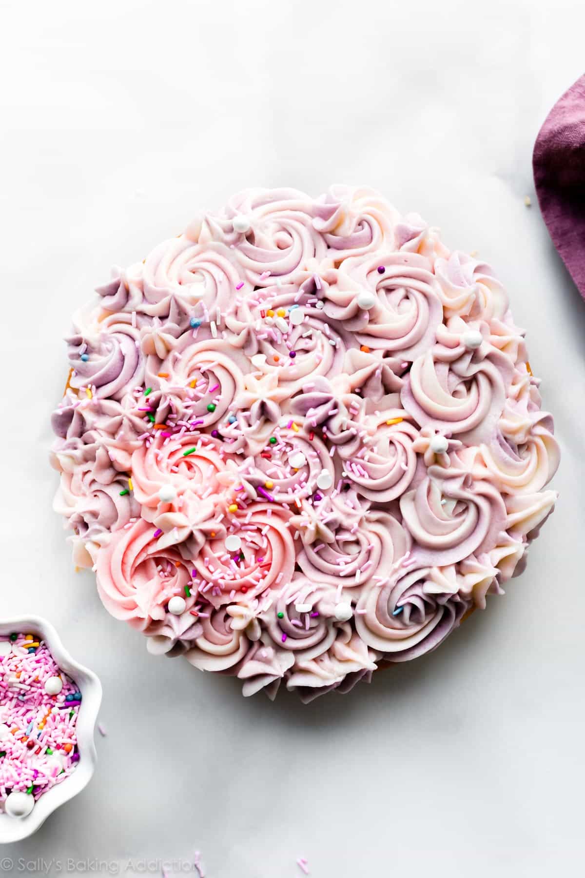 cake piped with pink and purple piped buttercream decoration