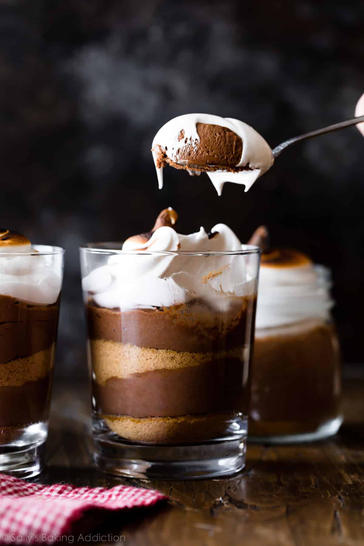 s'mores chocolate mousse in a jar with a spoon