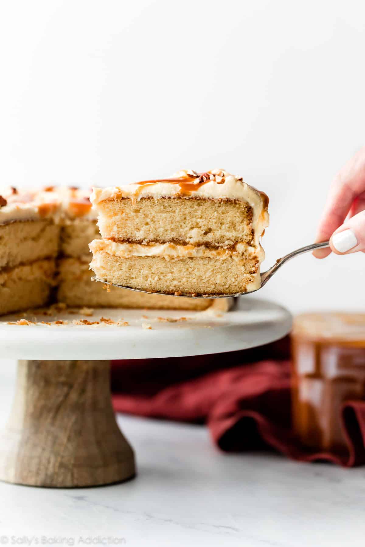 slice of burnt sugar caramel cake being removed from cake