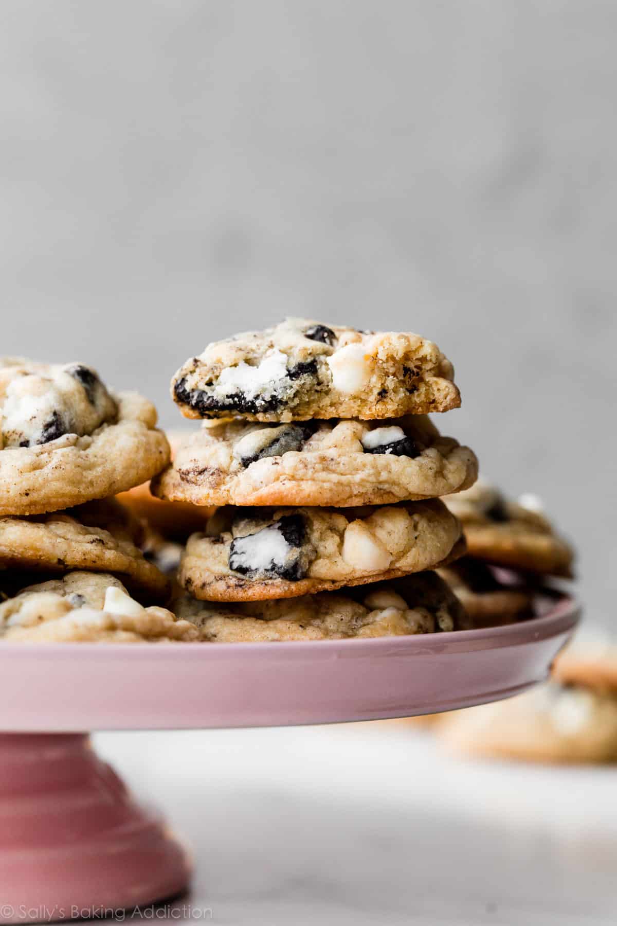 stack of cookies and cream cookies on pink cake stand