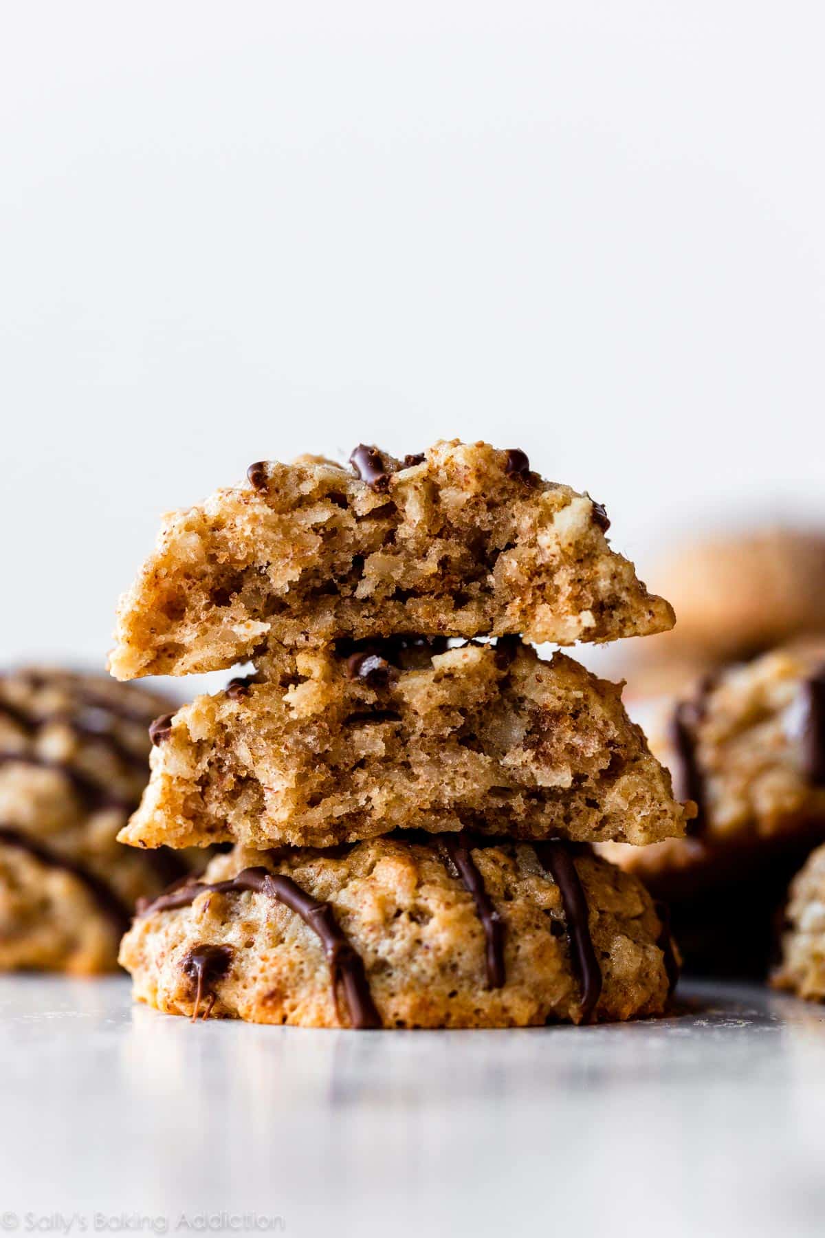 an almond butter coconut macaroon cookie cut in half and stacked on top of another cookie