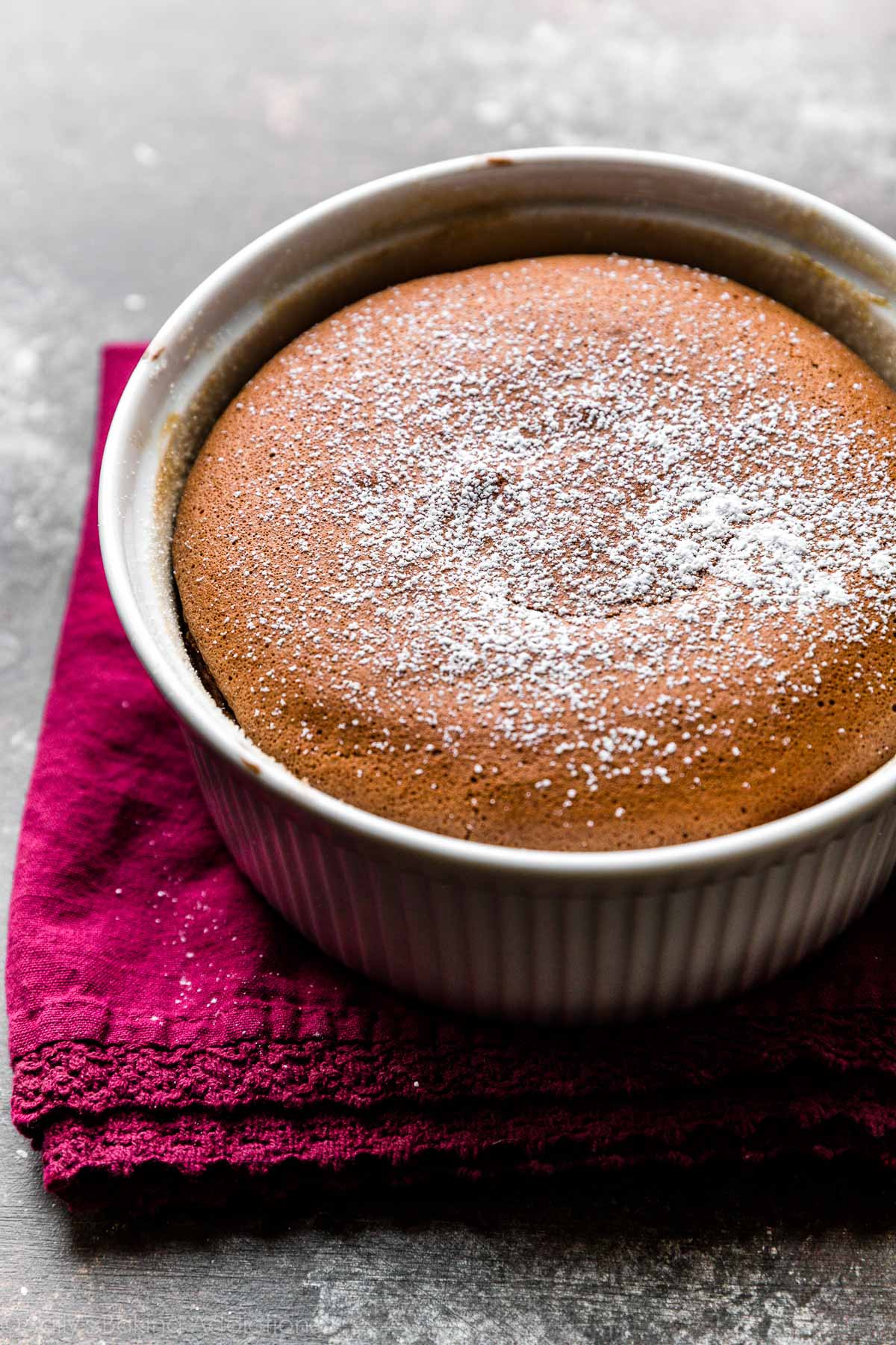 large chocolate souffle in a souffle dish