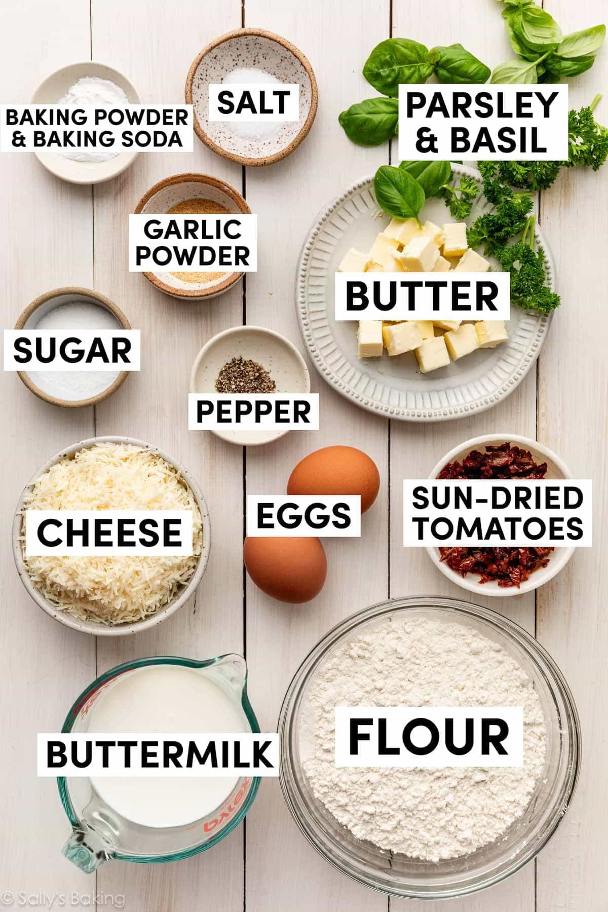 ingredients measured out including eggs, flour, buttermilk, herbs, cheese, pepper, and garlic powder.