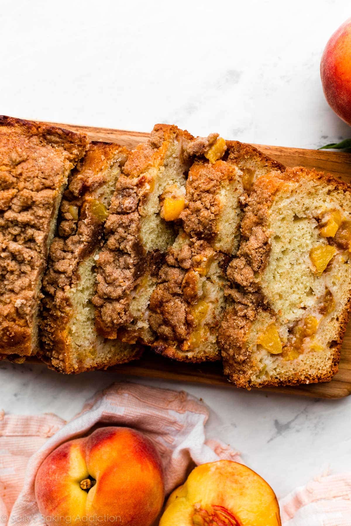 peach quick bread sliced on cutting board