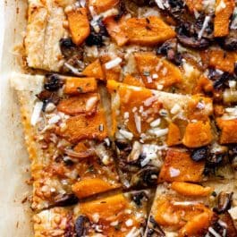 sliced butternut squash and mushroom tart with parmesan cheese