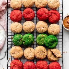 almond butter cookies rolled in white coarse sugar and red and green sanding sugar on cooling rack