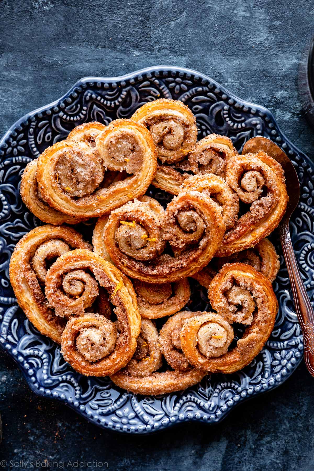 cinnamon spice palmier cookies on blue plate