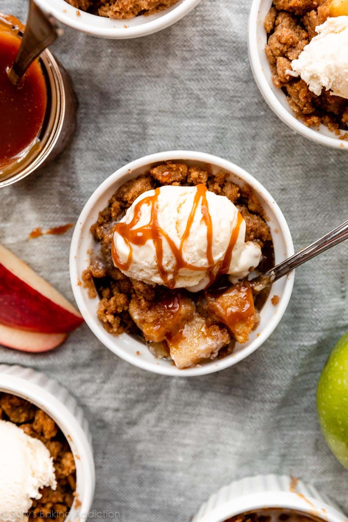 apple crumble in ramekin with ice cream and caramel on top