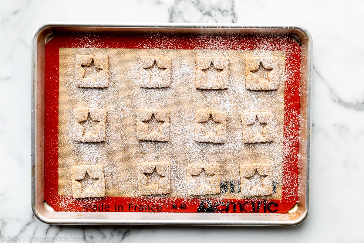 square-shaped hazelnut cookies dusted with confectioners' sugar