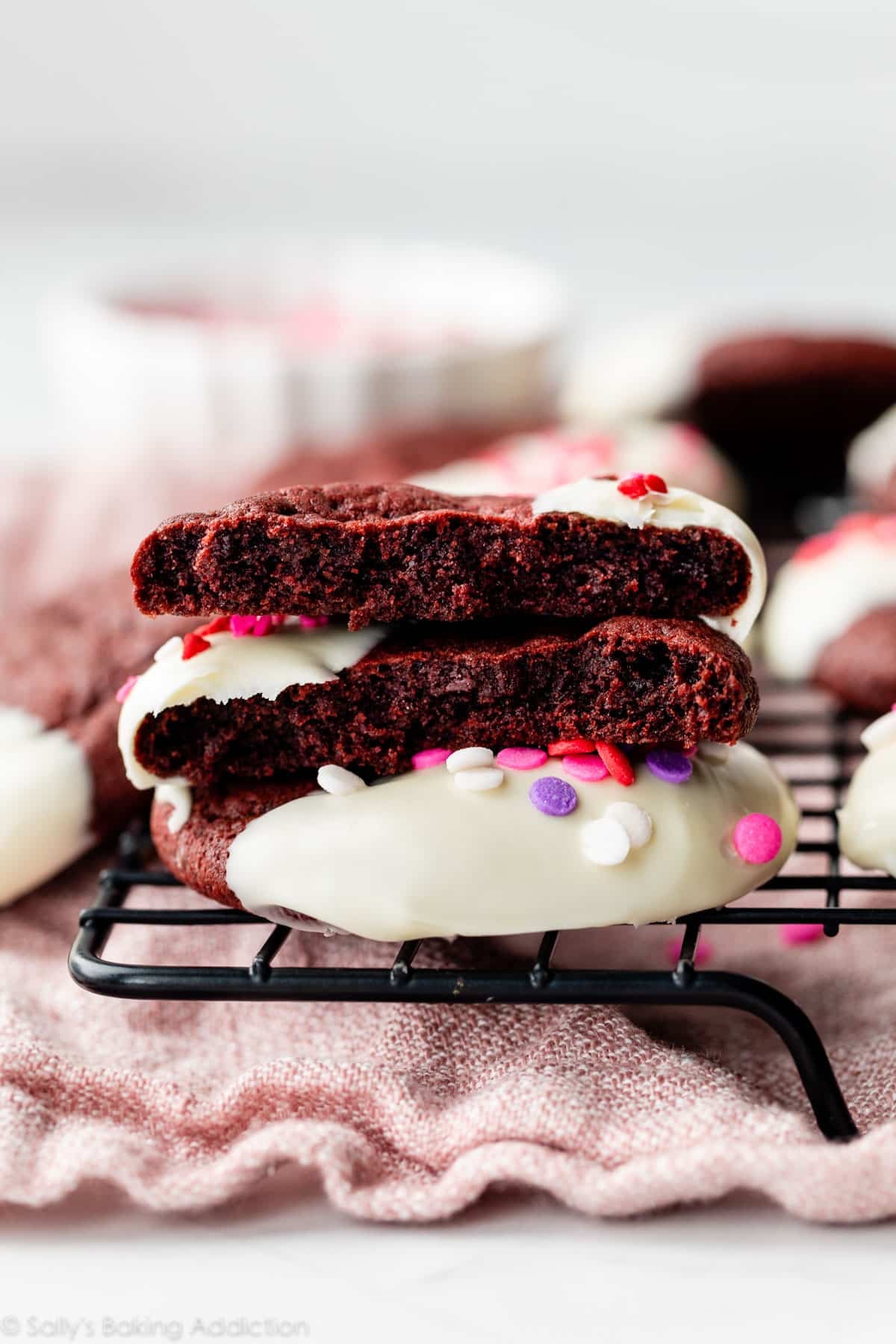red velvet cookie dipped in white chocolate and broken in half