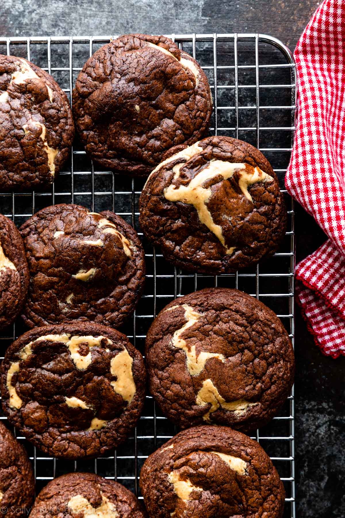 peanut butter swirled brownie cookies on wire cooling rack